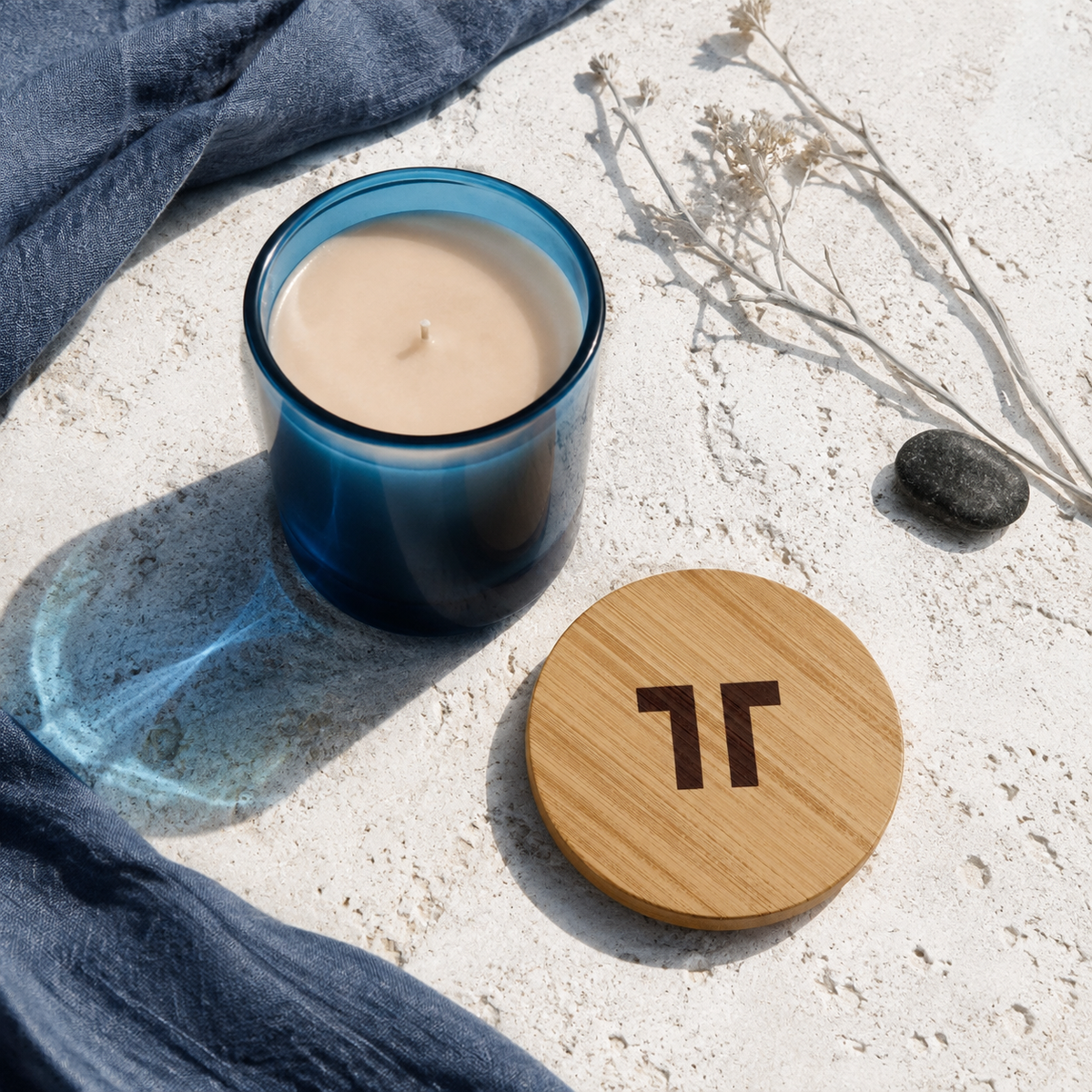 TenTen Leighton Blue 390g cobalt glass candle with bamboo lid in hard coastal light